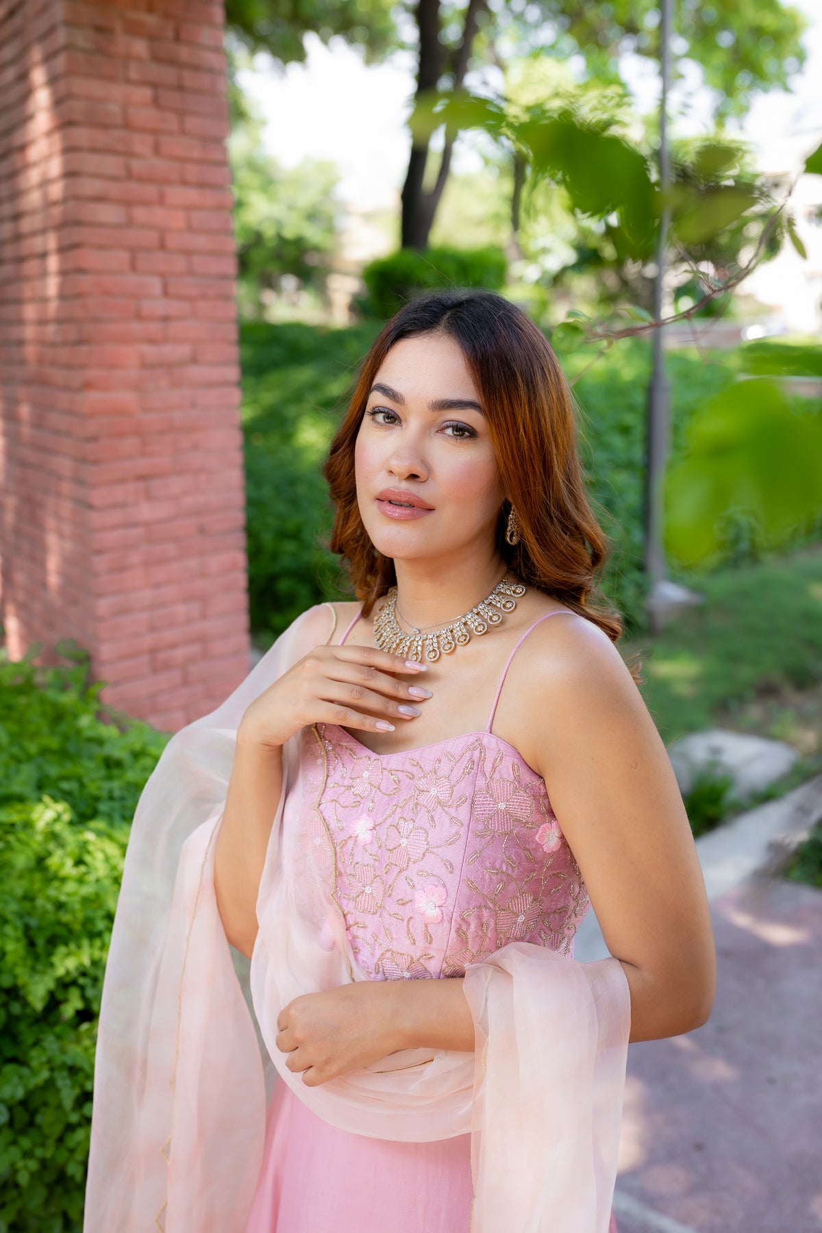 Side close up pillar view of Rashi Pink Lehenga Set.