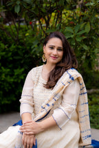 Front view of model sitting in Akanksha Suit set with dupatta.