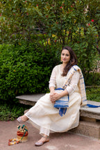 Front view of model sitting in Akanksha Suit set with dupatta.