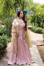 Right view of sitting Saira Blush Lehenga Set.