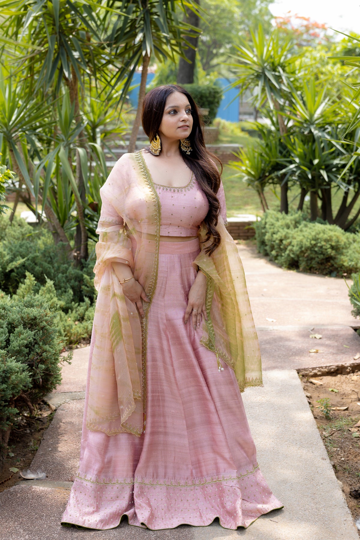 Right view of sitting Saira Blush Lehenga Set.