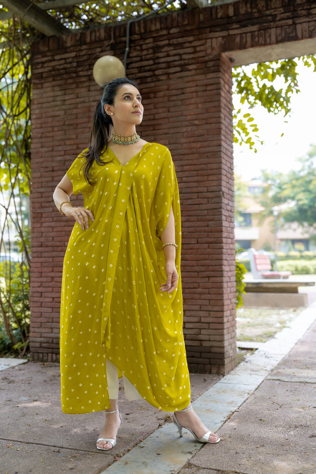 Model front pose in Noor Bandhani yellow Kaftan Set