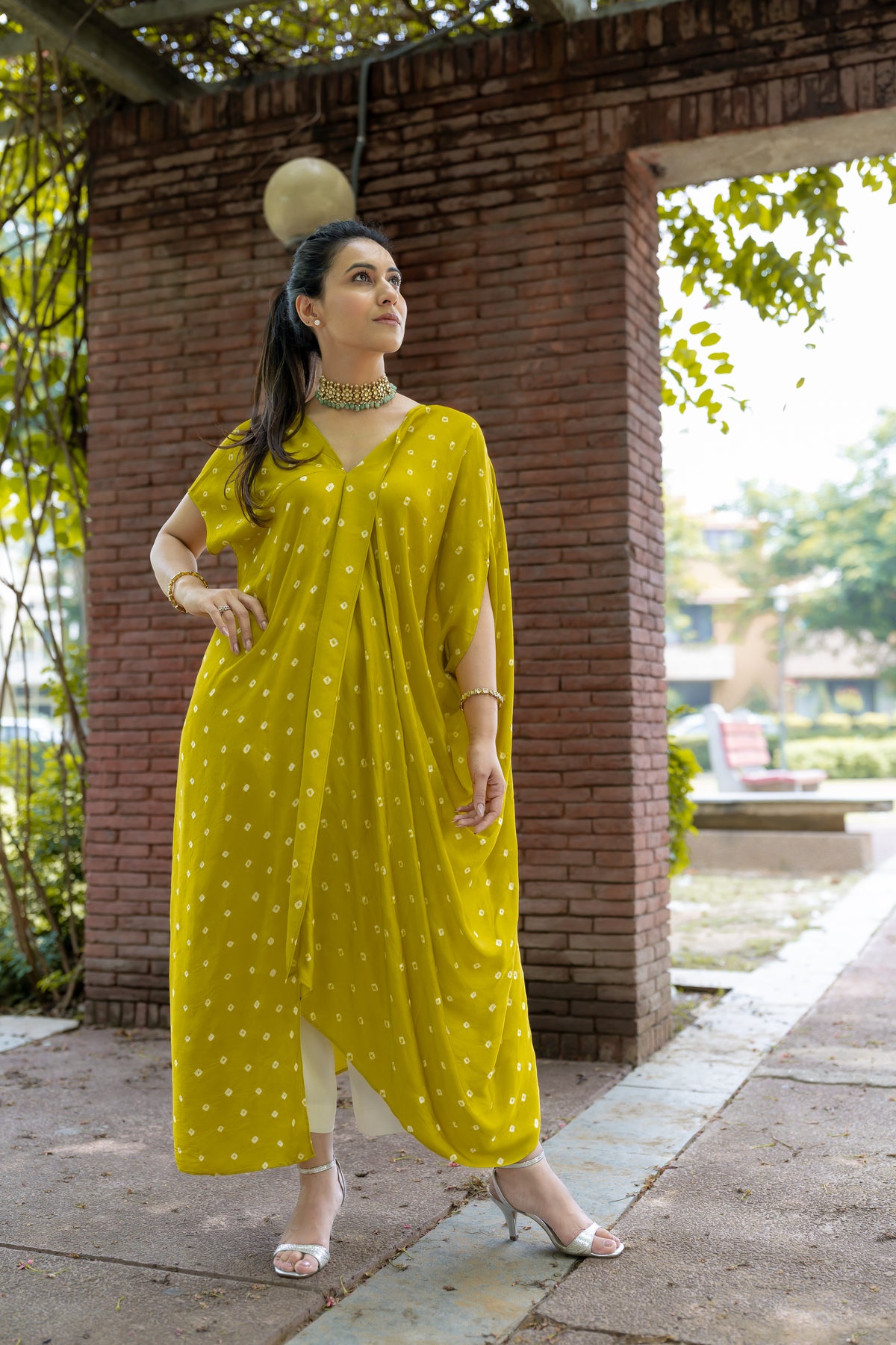 Model front pose in Noor Bandhani yellow Kaftan Set
