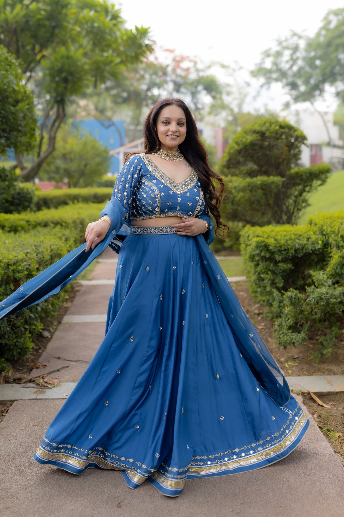 model twirl in Geet Royal Blue Lehenga Set.