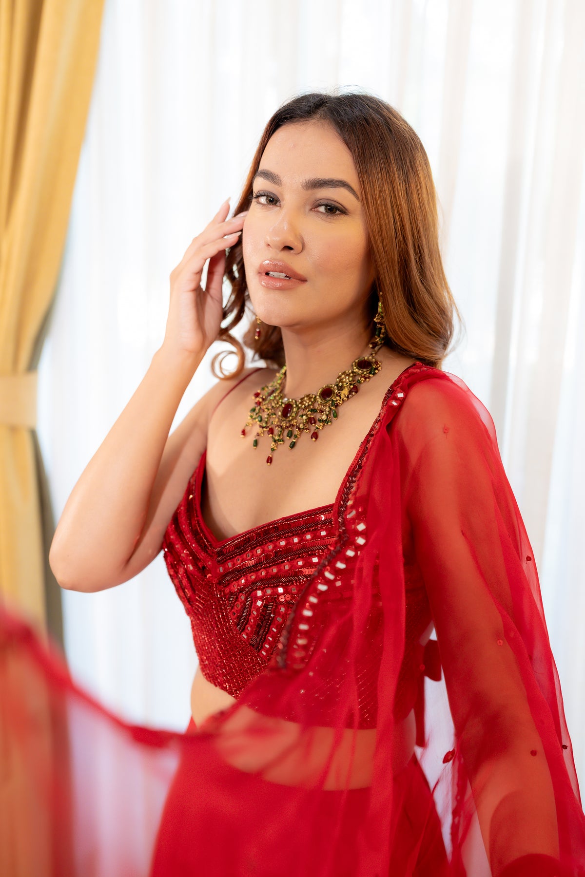 Model posing in poja knotted sheesha blouse/skirt set.