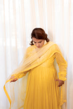 Model pose in Sunehri Anarkali Set.