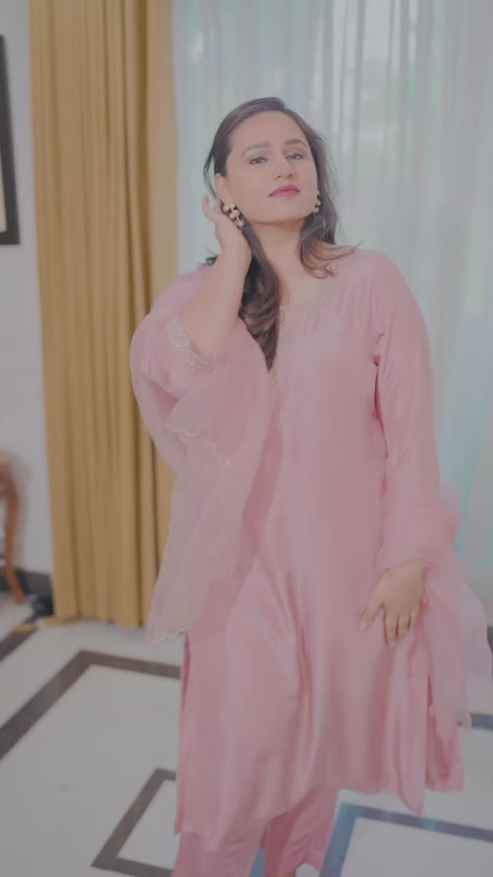 Video of a model walking and turning around to showcase the fit and movement of a Pink Organza Kurta Set .