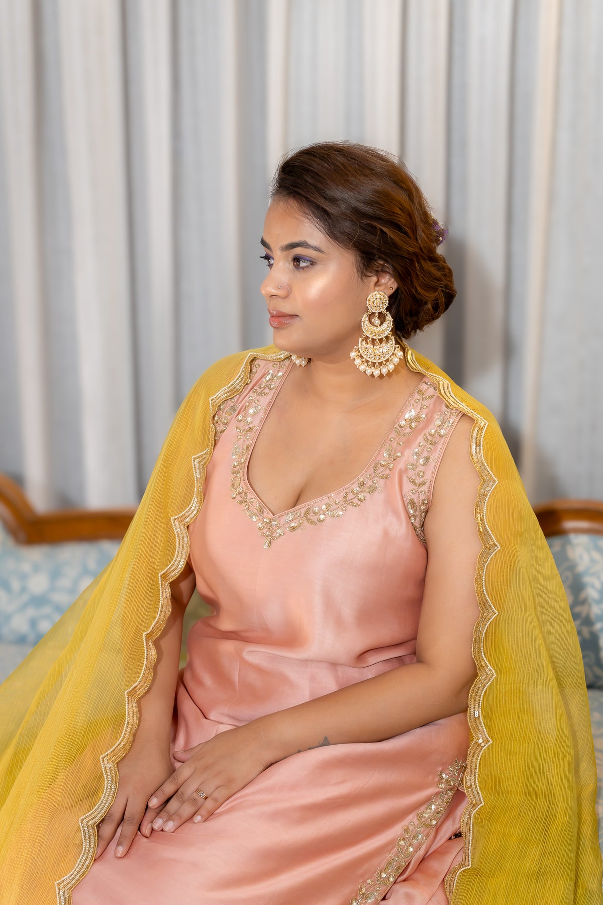 Sitting close up view of Gulnaar Peach Kurta Set with Mustard Dupatta.
